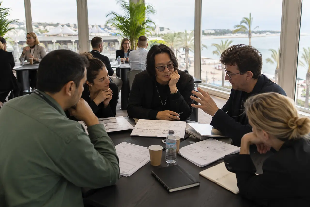 Professionnels adultes discutant d’un projet au Marché du Film à Cannes